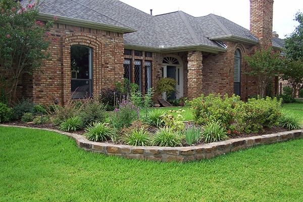 Regrading Your Yard - landscaping with stone retaining wall