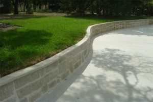 hardscape construction - concrete driveway with stone retaining wall