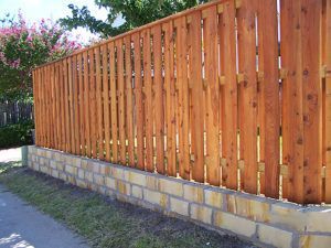 hardscape construction - wood fence with stone foundation