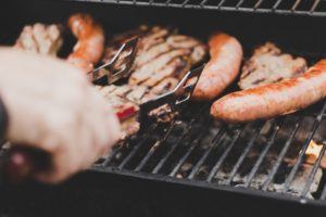 outdoor kitchen - man grilling on bbq