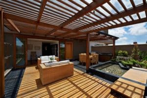 outdoor kitchen - outdoor kitchen space with seating and pergola cover