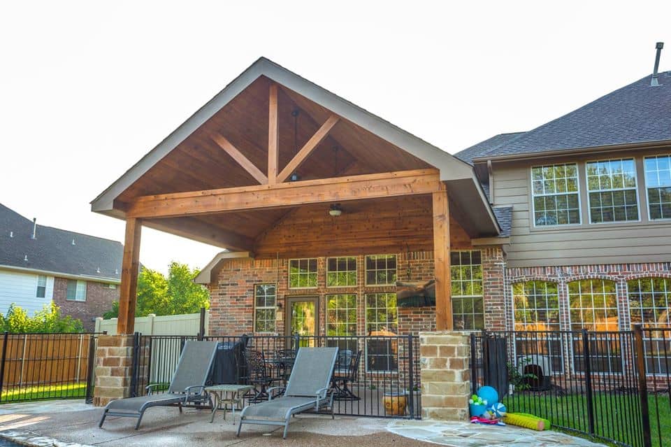 outdoor living spaces - wood patio cover next to pool and pool chairs