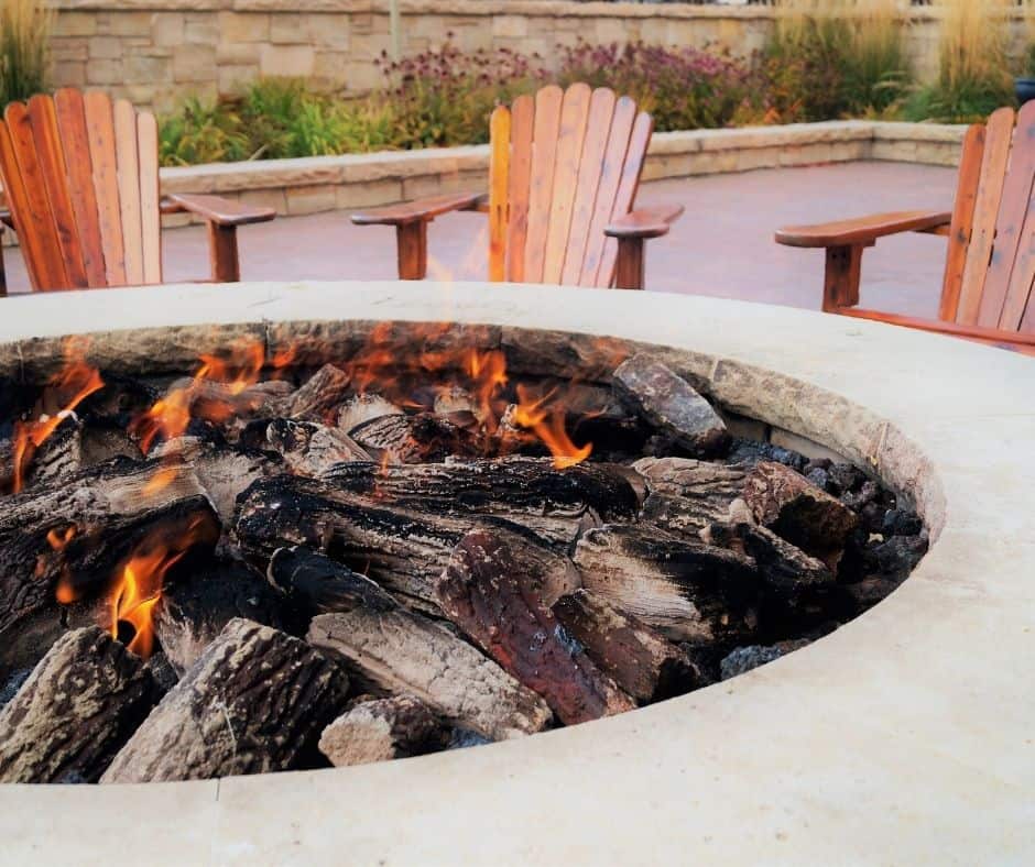 fire features - stone fire pit with wood chairs