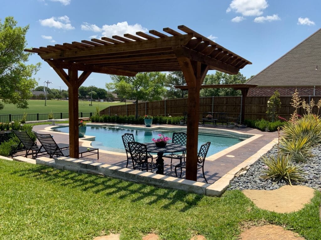 wood structure in backyard with a pool - What Is the Difference Between Hardscape and Landscape?